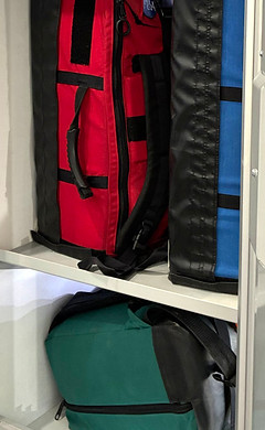 red, blue, and green backpacks