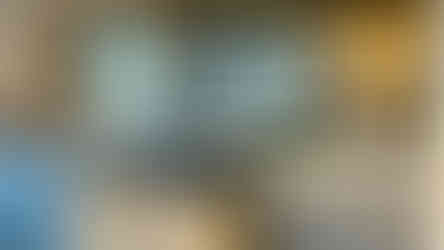 Toughened foxed mirror splashback in rustic kitchen, bespoke made to reflect light and enhance the handcrafted cabinetry.