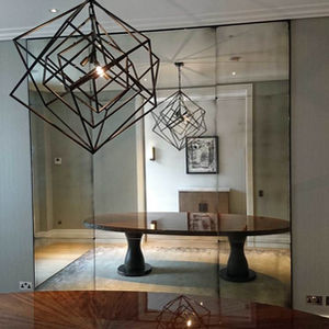 arge wall mirror installation reflecting light and expanding space in a modern living room