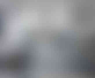 Distressed silver antique mirror splashback fitted in a contemporary kitchen with white cabinets and pendant lights, handcrafted by Mirror Works.