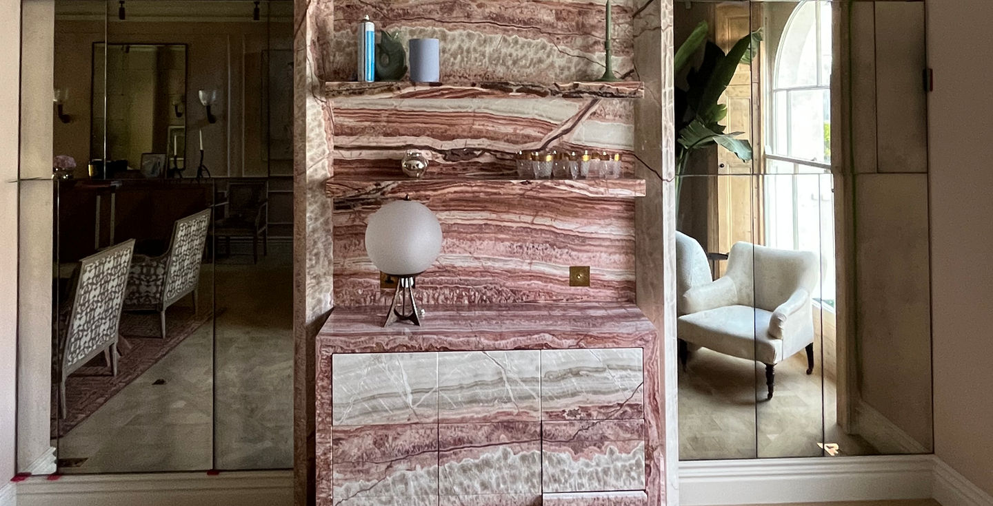 luxury living room with bespoke mirror feature wall adding light and depthroom