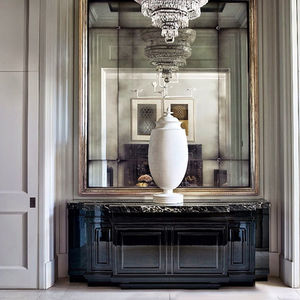custom-designed mirror feature wall with chandelier and console table, enhancing light and luxury in entrance hall