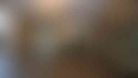 aged mirror wall feature reflecting chandelier lighting in corporate reception