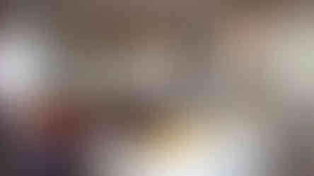 mirrored wall panels behind sofa adding light and depth to contemporary living room