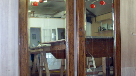 replacement mirror installed in restored vintage armoire showing matched wood frame and hand-silvered glass finish