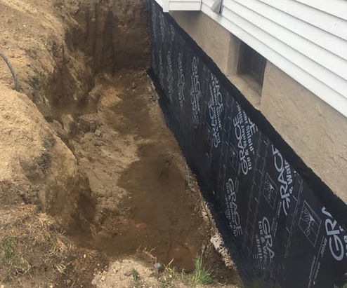 A waterproofing membrane is installed on the side of the foundation wall