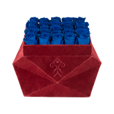 Blue roses displayed in burgundy gift box for special occasions