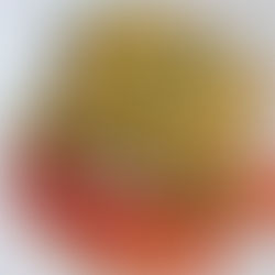 Toast topped with a creamy salad mix, featuring diced tomatoes and greens, on a white plate with sliced strawberries on the side.