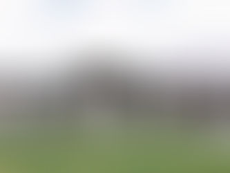 Front exterior view of the Violet plan, a modern prairie-style home with hip rooflines, a covered porch, and clean architectural details.