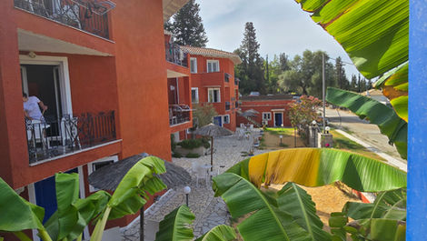 View of a resort complex with orange buildings and banana trees