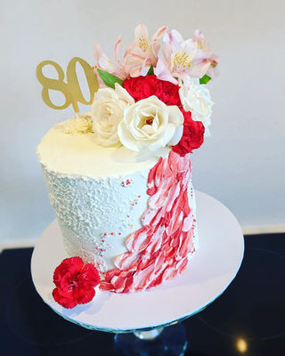 red and white buttercream flowers cake.webp