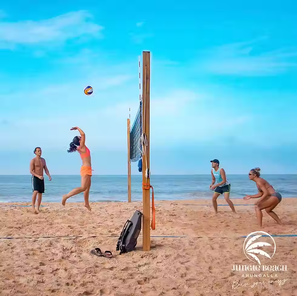 Two Couples playing Beach Volleyball