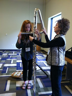 Longtime member Penny Griffey letting festival attendees play her contrabass flute, 2014