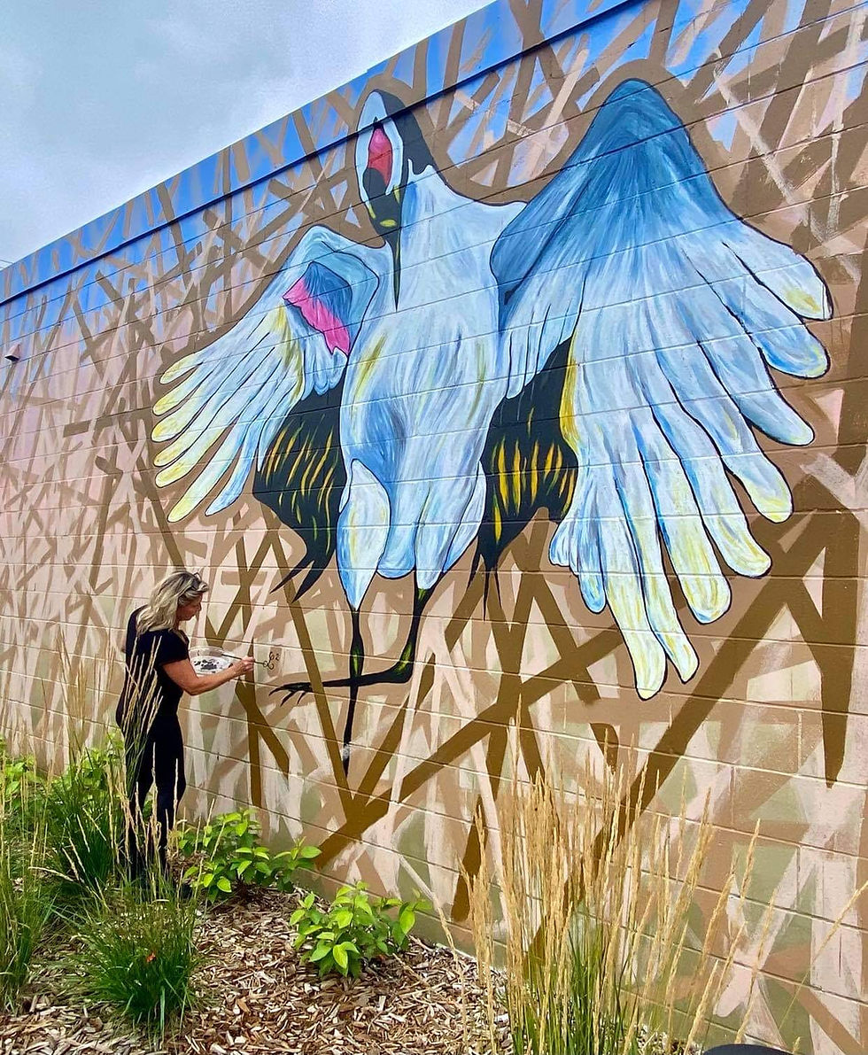 Lizanne Laurin artist putting the finishing touches for a mural in the community bringing awareness for endangered species. artwork conceptualized at L2 Studio.