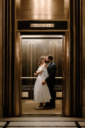bride and groom in elevator wisconsin capitol