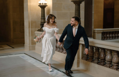 bride and groom running in the wisconsin capitol
