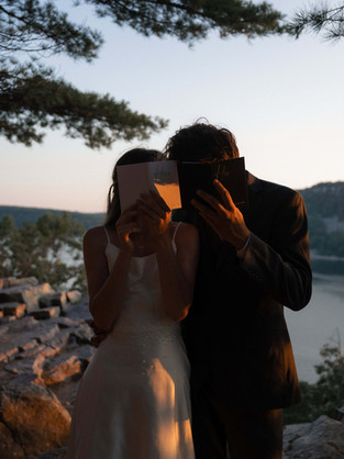 bride and groom with vow books