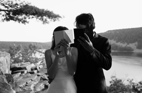 bride and groom with vow books