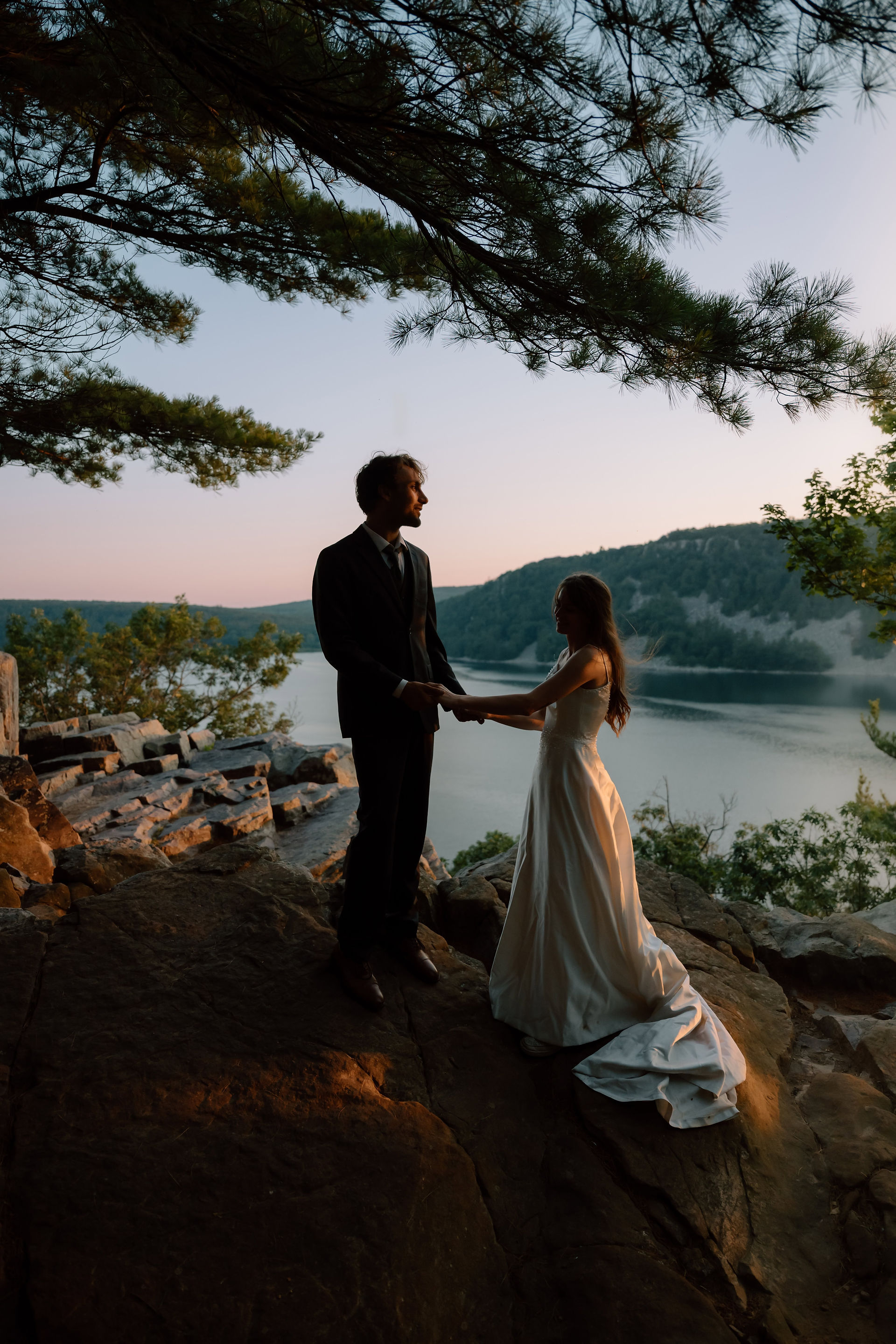 bride and groom at devils lake east bluff trail at sunset