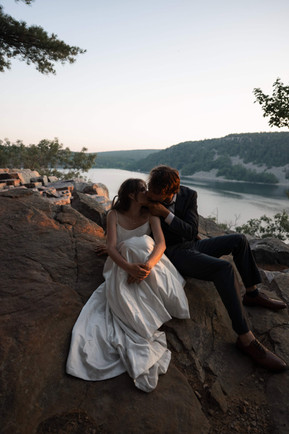 bride and groom at devils lake east bluff trail at sunset