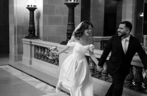 bride and groom running in the wisconsin capitol