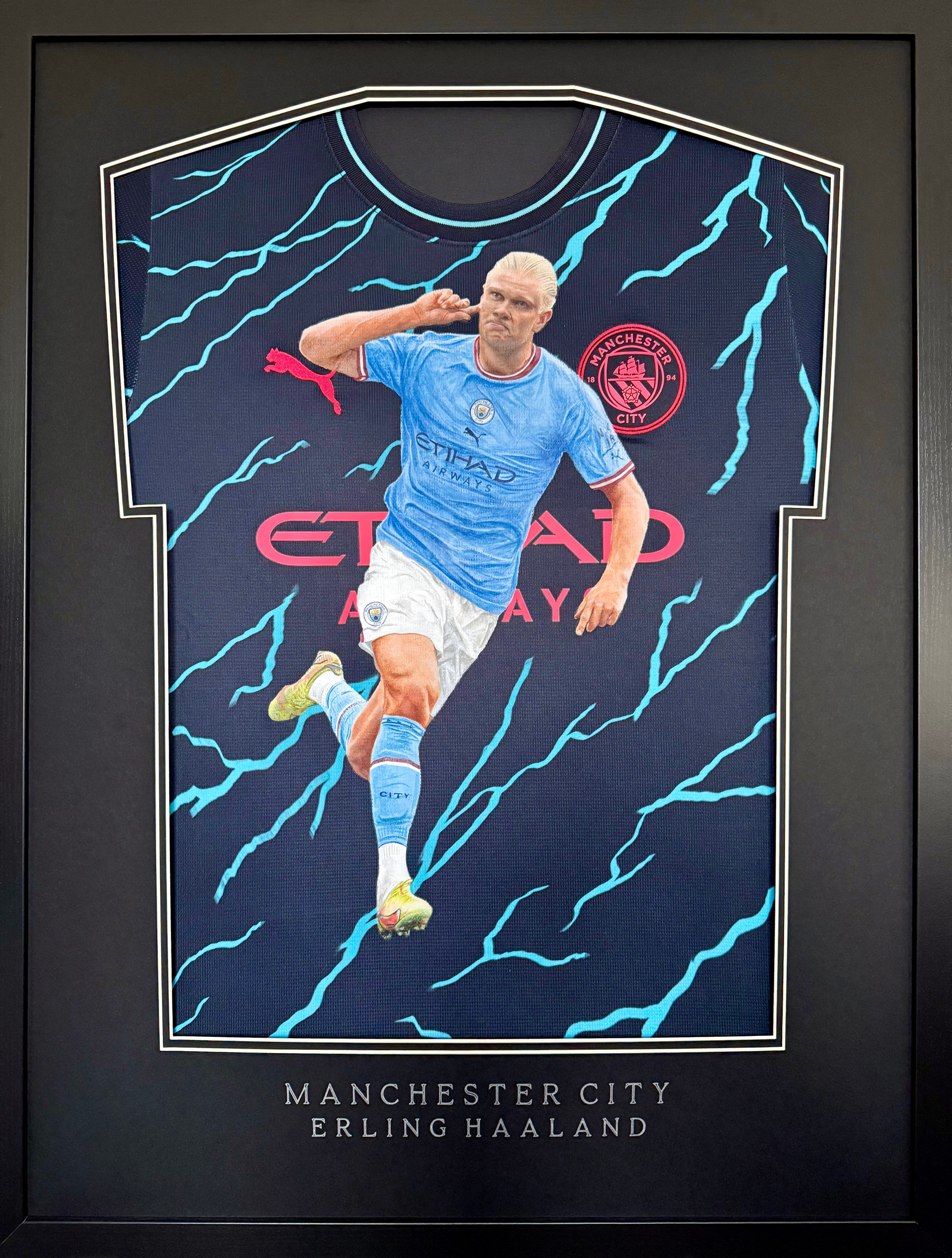 Framed painted jersey of Manchester City striker Erling Haaland hand painted by Sports Jersey Artist Scott Strachan