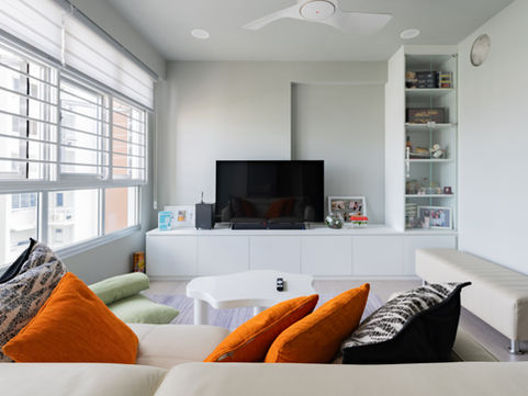 a living room with a ceiling fan and a flat screen tv