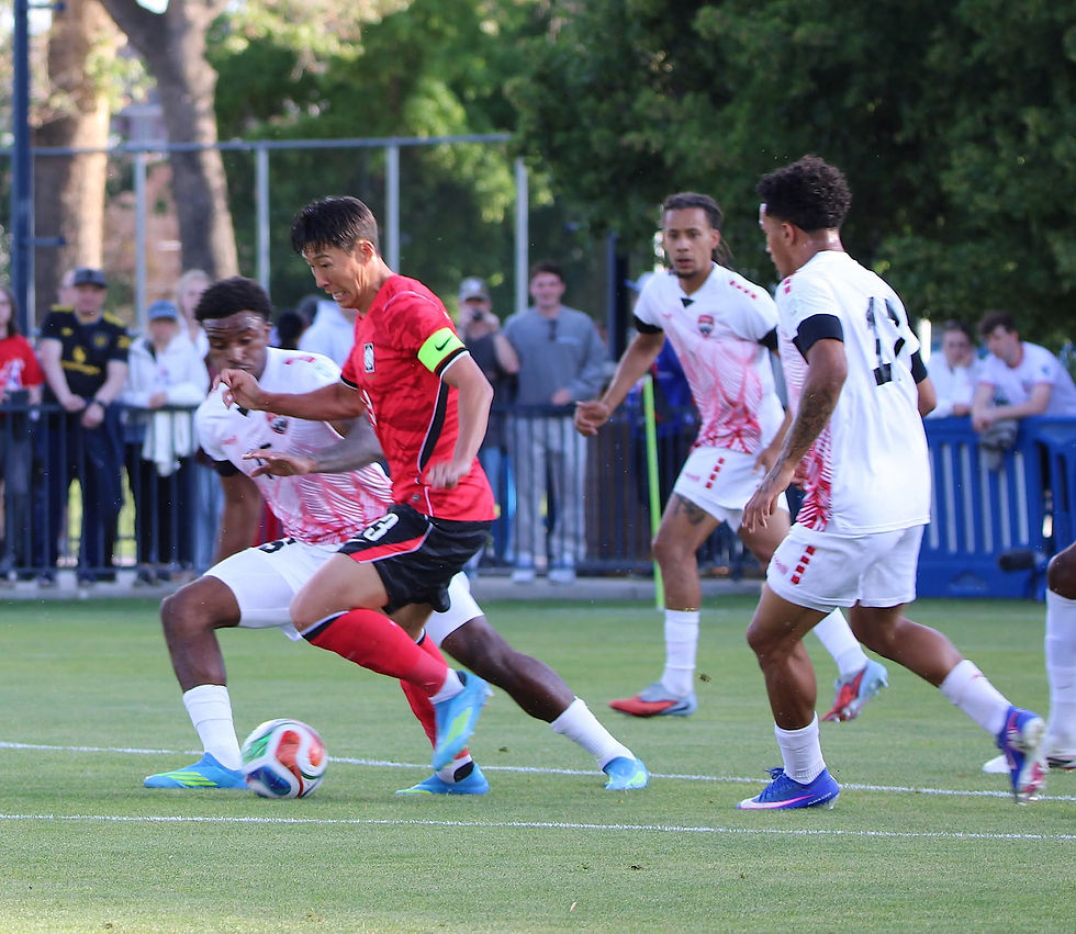 South Korea captain Son Heung-min (second from left) takes on TT's Dante Sealy (left) during an international friendly in Utah on May 30. Photo courtesy TT Football Association
