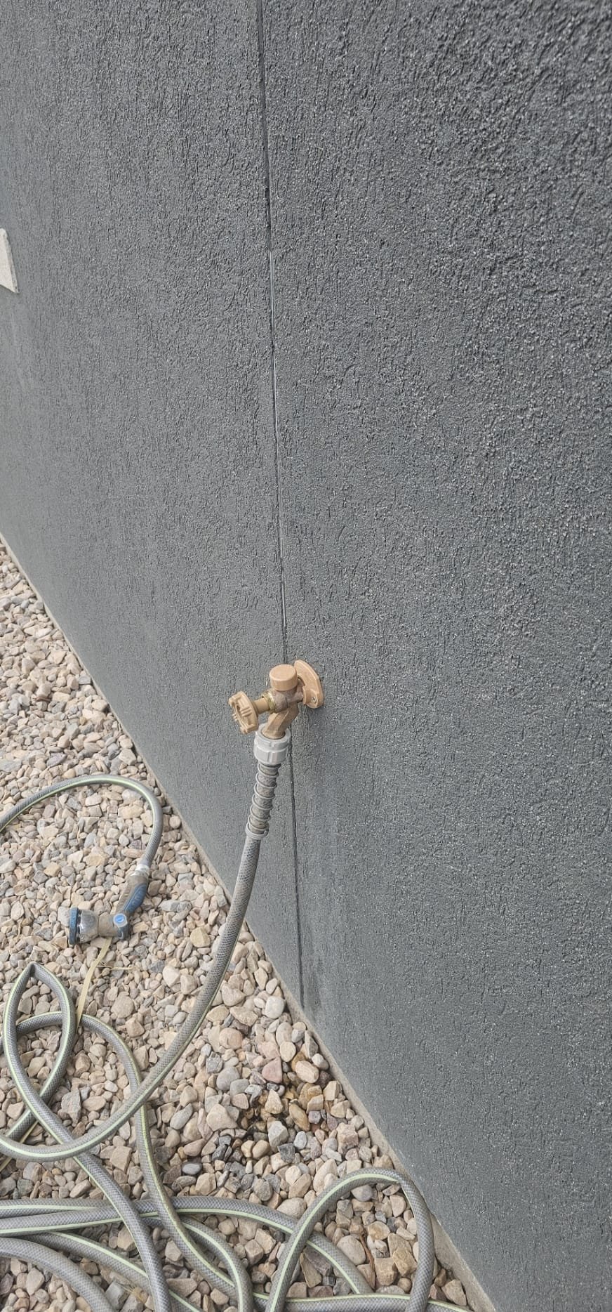 Close-up of a broken kitchen faucet, highlighting the potential benefits of leaky faucet repair. Focus on the dripping water, symbolizing water waste and increased utility bills that can be avoided with timely dripping water faucet repair.