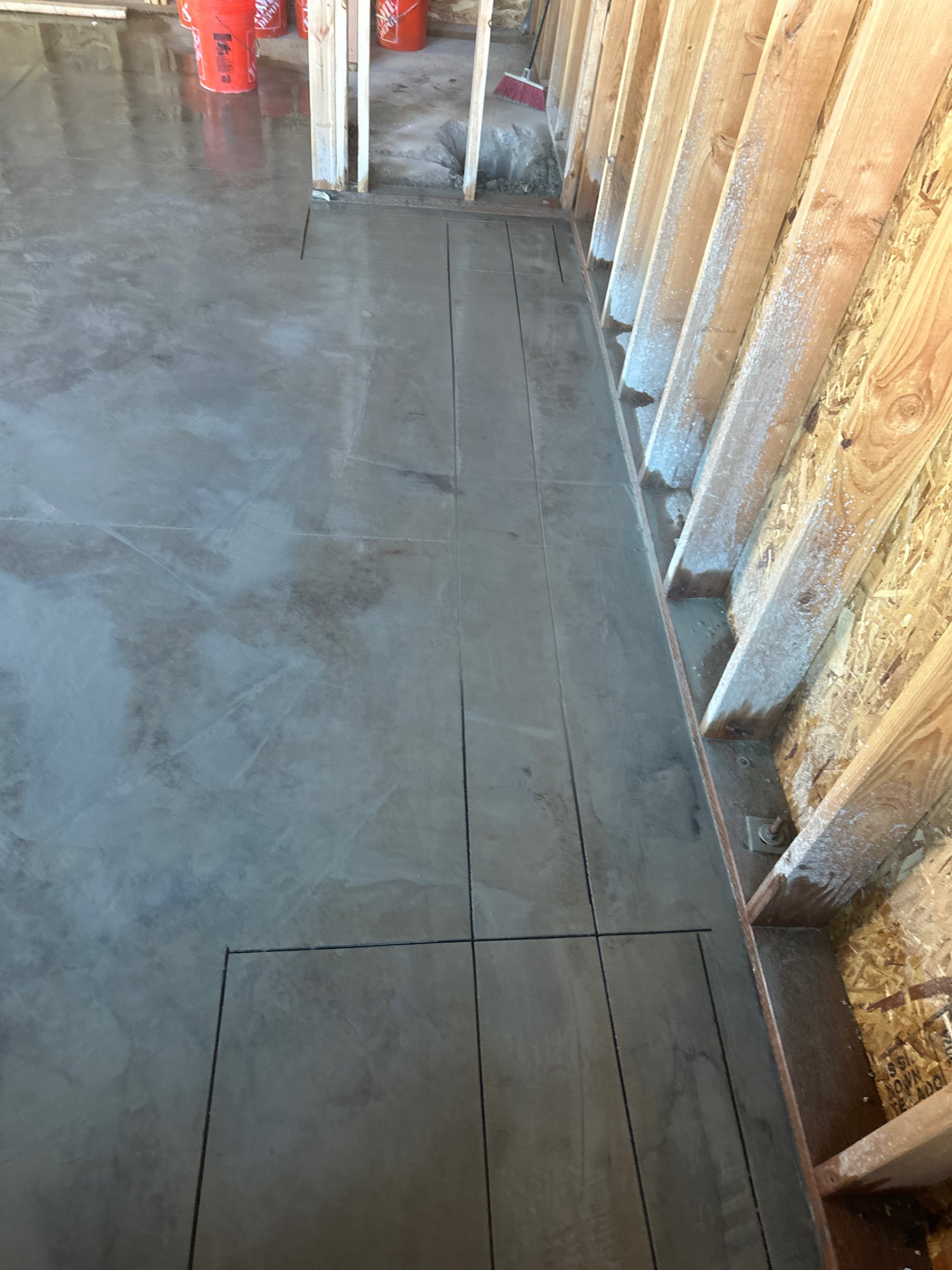 Image depicts a powerful sewer jetter hose effortlessly clearing a clogged pipe, symbolizing the efficiency and cost-effectiveness of septic pumping services. In the background, a commercial building suggests 24-hour availability for urgent sewer replacements, highlighting reliable and immediate solutions.