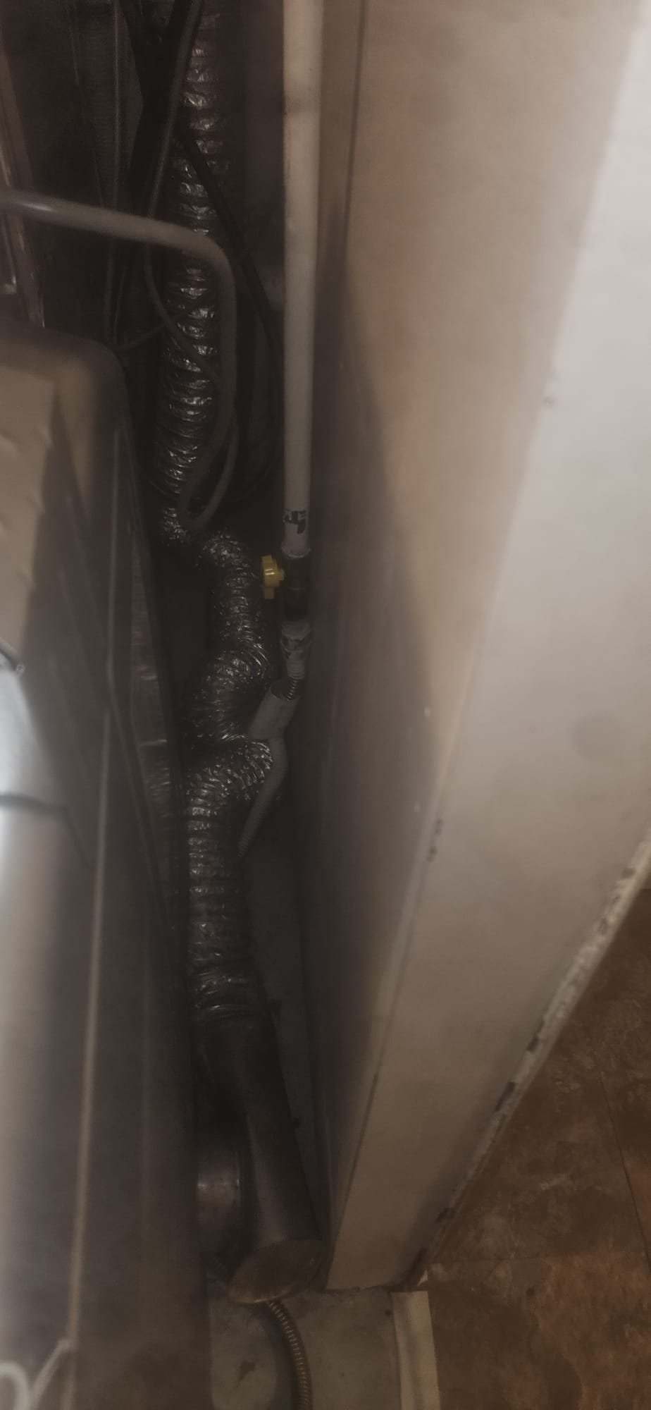 A gleaming, well-organized arrangement of kitchen sink pipes below a stainless steel sink basin. The clean, dry pipes suggest a leak-free system, indirectly referencing the frustration of a leaky tub faucet. The neat installation hints at the ease of a DIY project, perhaps similar to learning 'how to install a drinking water faucet,' showcasing a sense of accomplishment and a functional, modern kitchen.