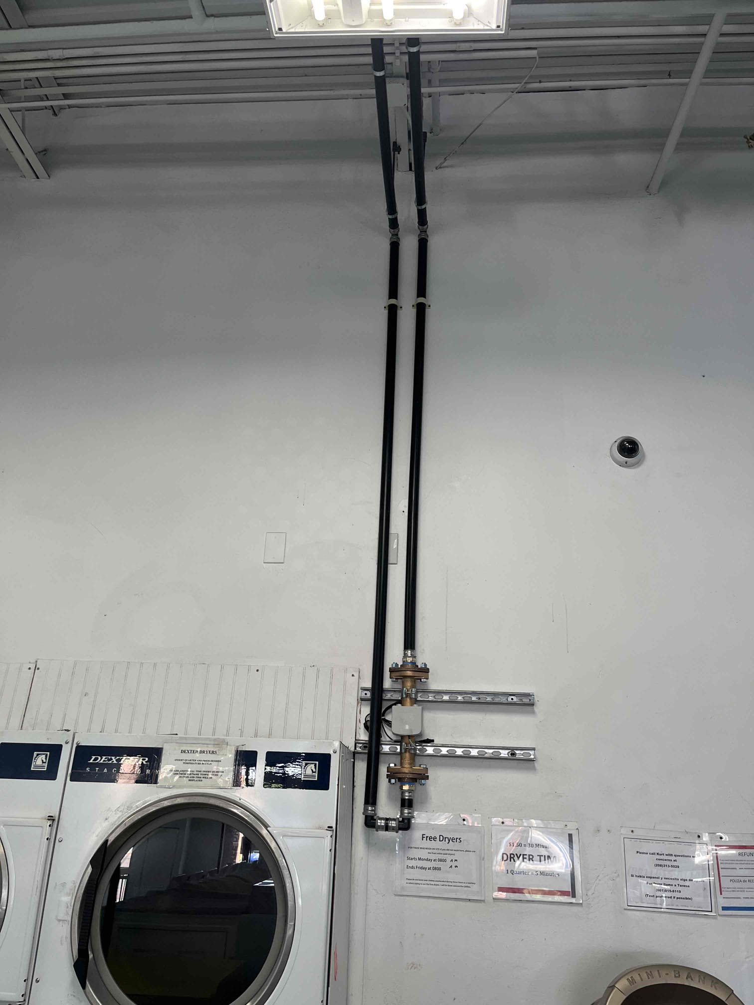 Close-up of white PVC pipe tightly wrapped with waterproof repair tape, effectively sealing a leak. Water droplets are visible on the tape's surface, highlighting its resistance and efficacy in plumbing leak repair.