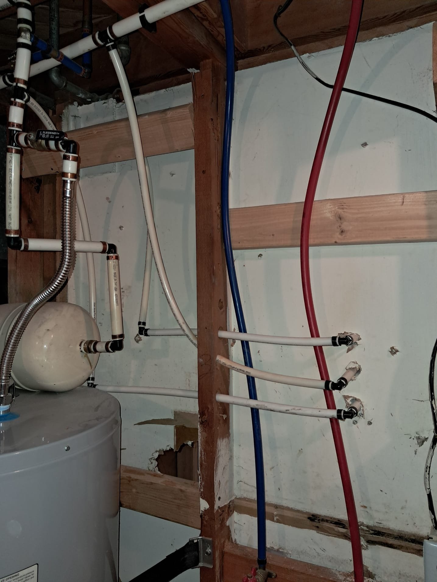 Shiny, new replacement drain valve installed on a Rheem water heater, replacing a corroded valve. Close-up shot highlighting the clean connection, preventing leaks and ensuring efficient drainage. A pristine replacement tub drain is visible in the background, emphasizing the ease and benefits of drain replacements.