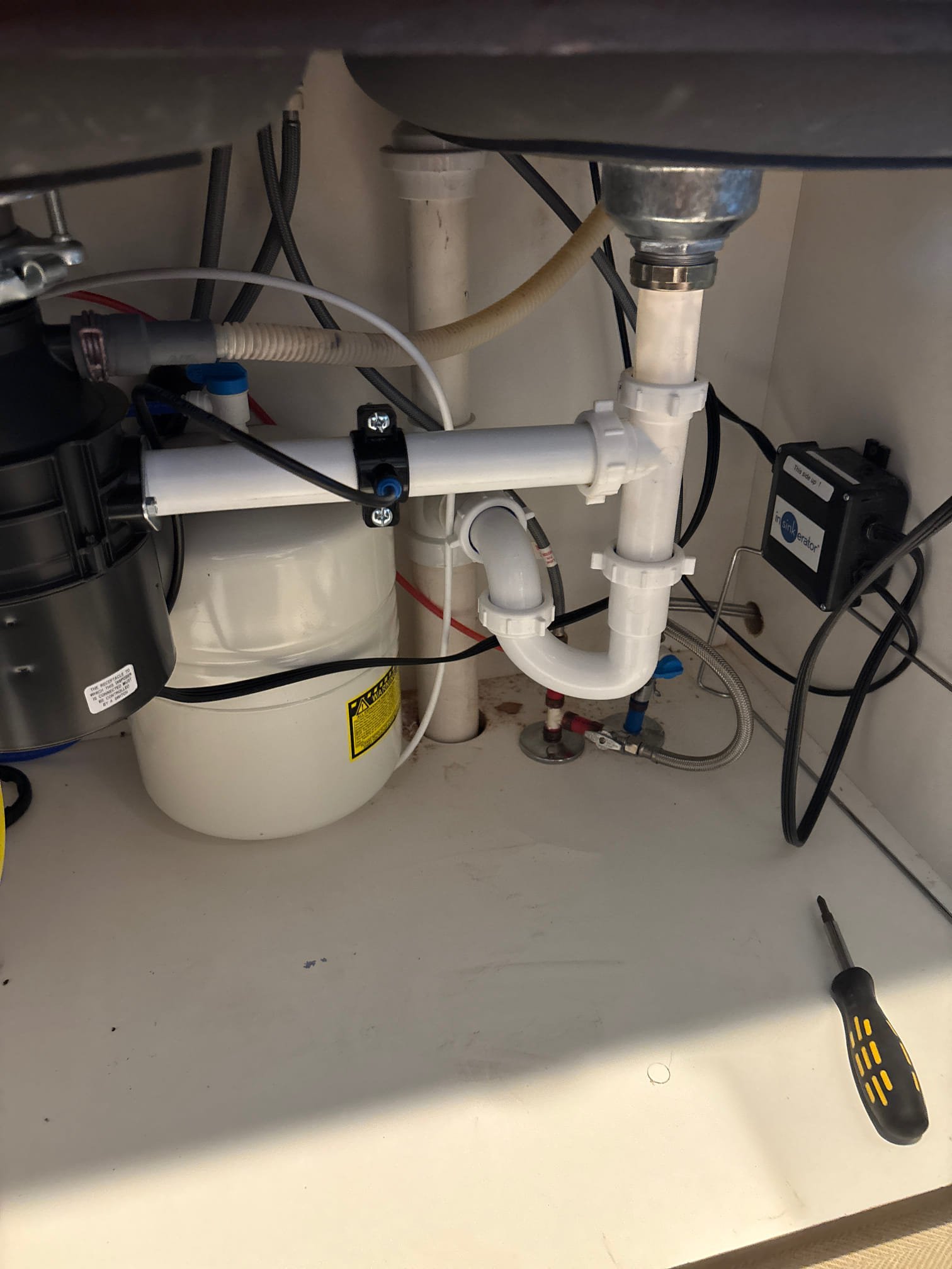 Sparkling clean bathroom sink and bathtub gleam in a well-lit bathroom, hinting at the air's freshness and lack of mildew, thanks to an unseen air cleaner maintaining a pristine environment.