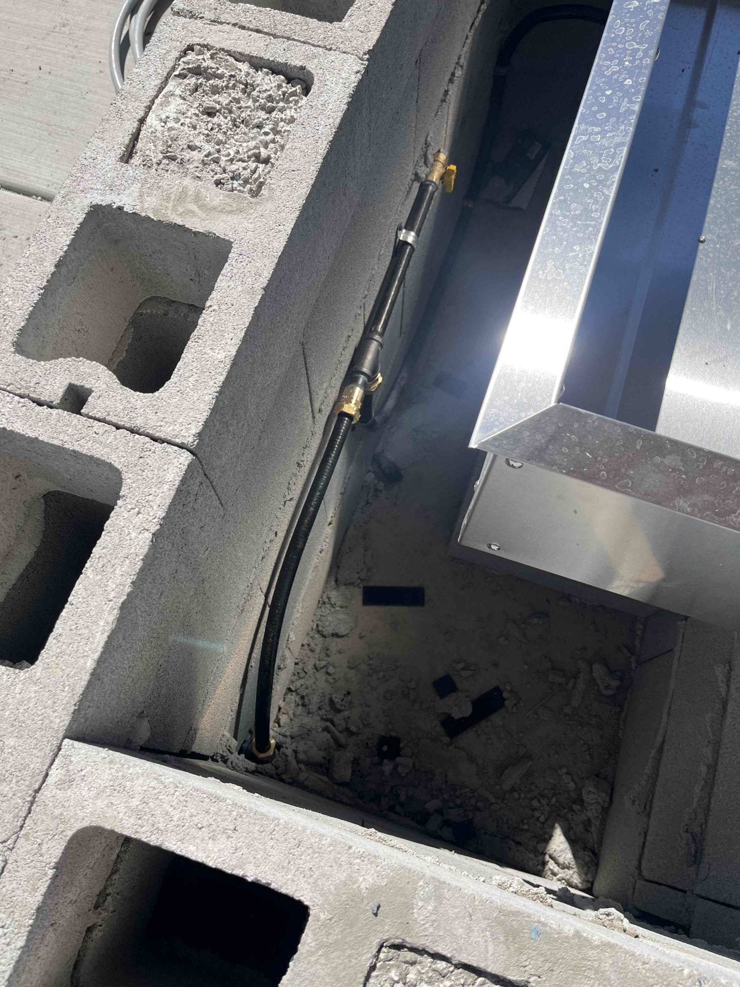 Smoke-filled room, partially obscured reverse osmosis system gleaming in the background, symbolizing clean water restored after fire. Technician in protective gear repairing smoke damage, highlighting immediate restoration and purification services.