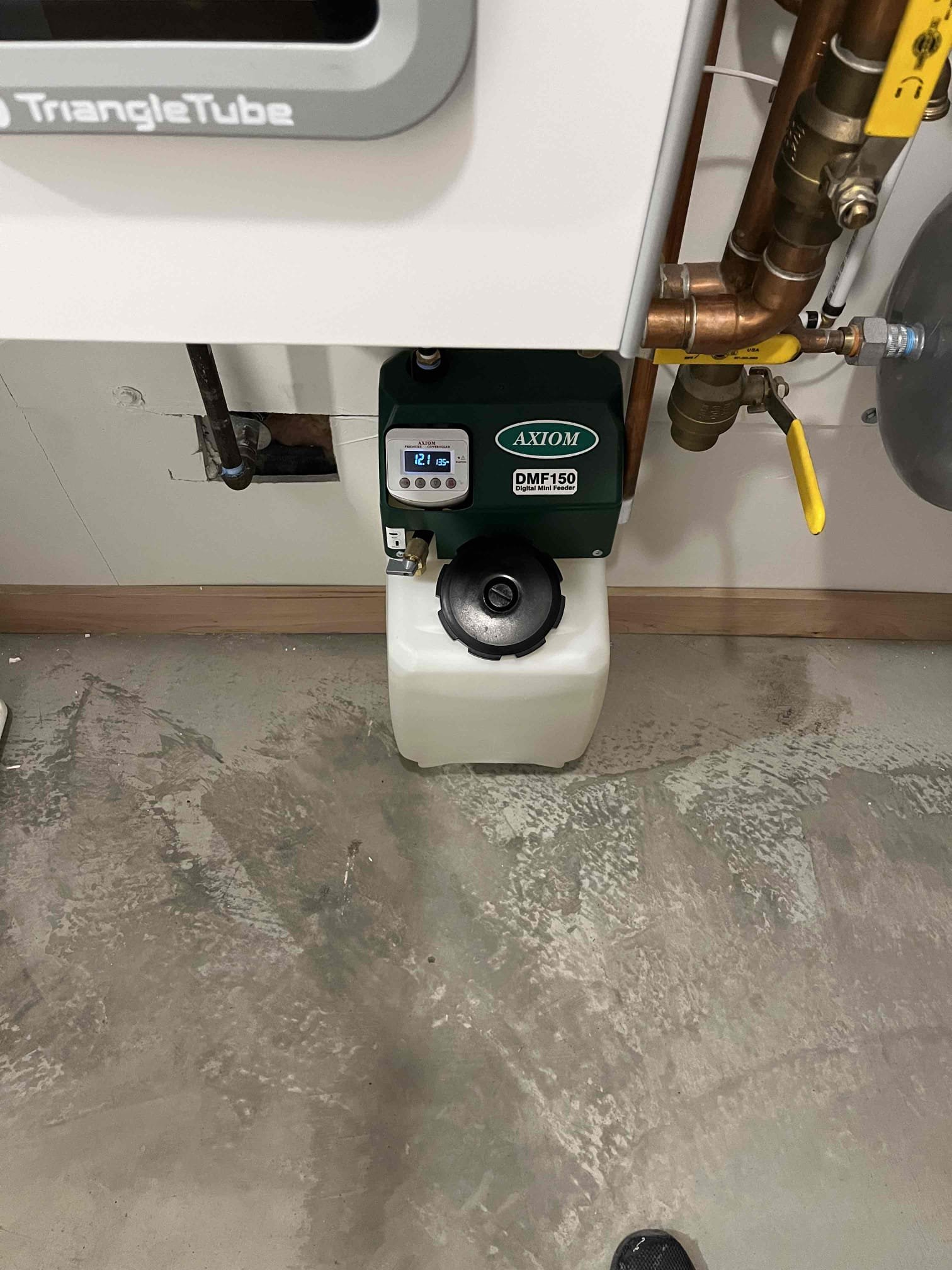 A close-up image showcasing a cheap borescope snaking through the internal components of a residential electric boiler. The visual emphasizes the borescope's thin, flexible design, highlighting its ability to access tight spaces and inspect crucial parts of the boiler system for potential issues like corrosion or scale buildup, thus preventing costly repairs.