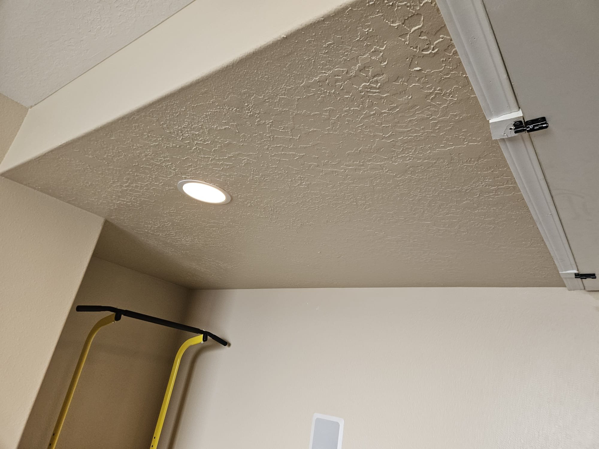 Close-up of a clean media air filter, highlighting its dense filtration layers. Tiny particles are visibly trapped, demonstrating effective purification. In the background, a blurred image suggests a well-maintained central air system, implying professional, licensed maintenance. The overall image promotes the benefits of both media air filters and regular HVAC service for improved air quality, like a mini air filter working on a larger scale.