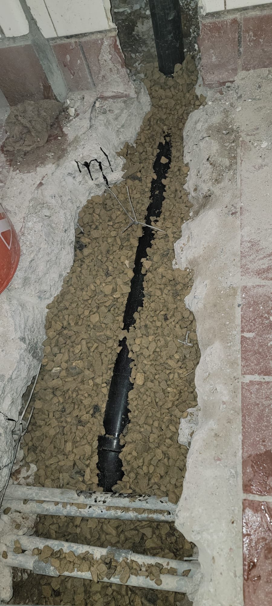 High-pressure jet cleaning a basement wall, removing debris and preparing the surface for waterproof spray application. Clean surfaces highlight the effectiveness of local basement waterproofing solutions.