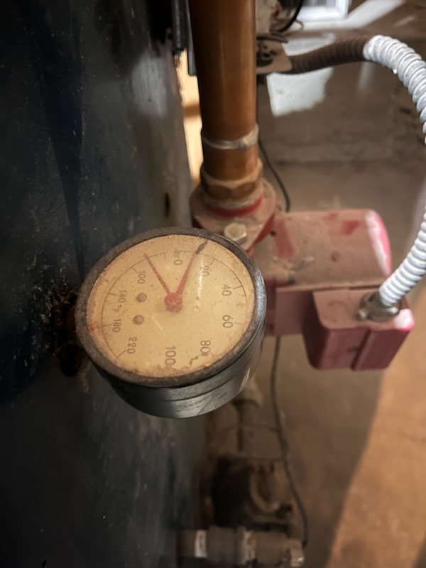 Image shows a plumber using a toilet snake to clear a severely clogged toilet filled with poop. The snake is visibly breaking up the blockage, demonstrating an effective solution for toilet repair and restoring proper drainage.