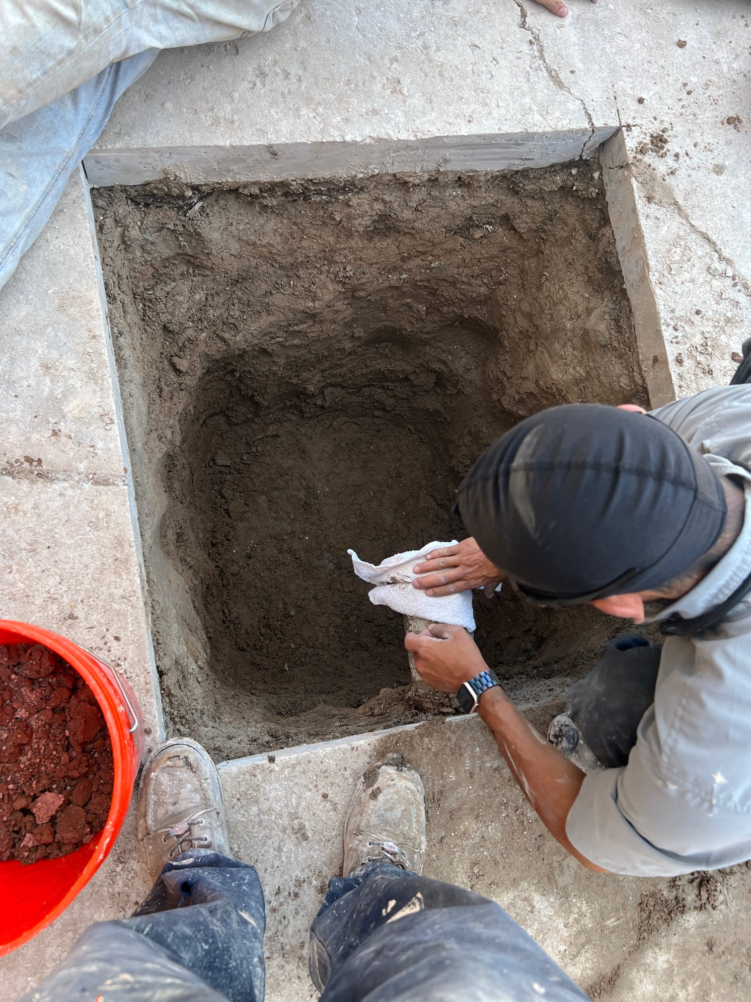 Hand auger drills into the earth, promising efficient solutions. Symbolizes accessing hidden utilities for HVAC or quick residential storm damage assessment, ensuring comfort and safety.