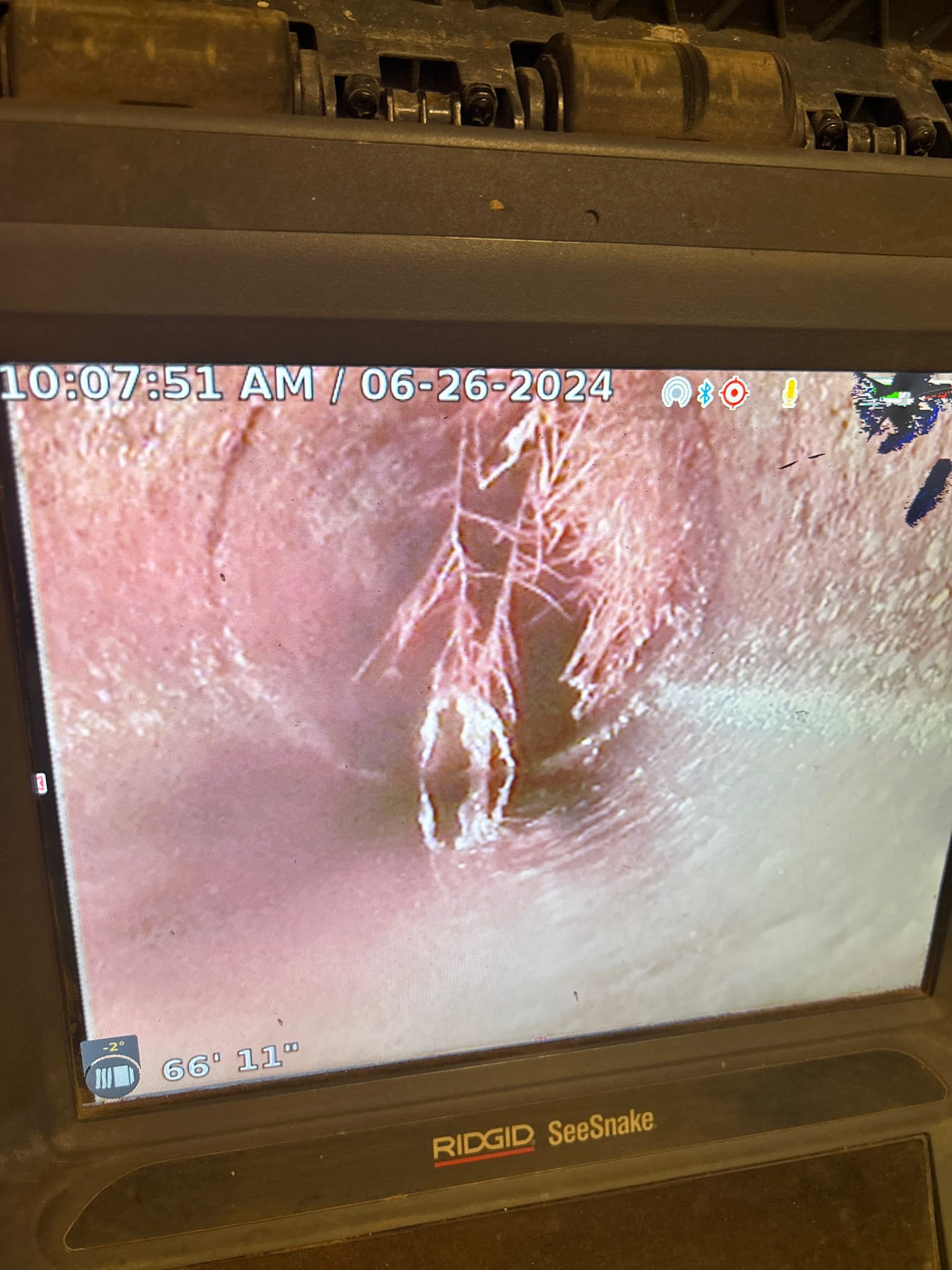 Technician inspecting a home's flood damage with clean, filtered city water visible in the background, symbolizing effective remediation maintenance and safe water supply after a flood.