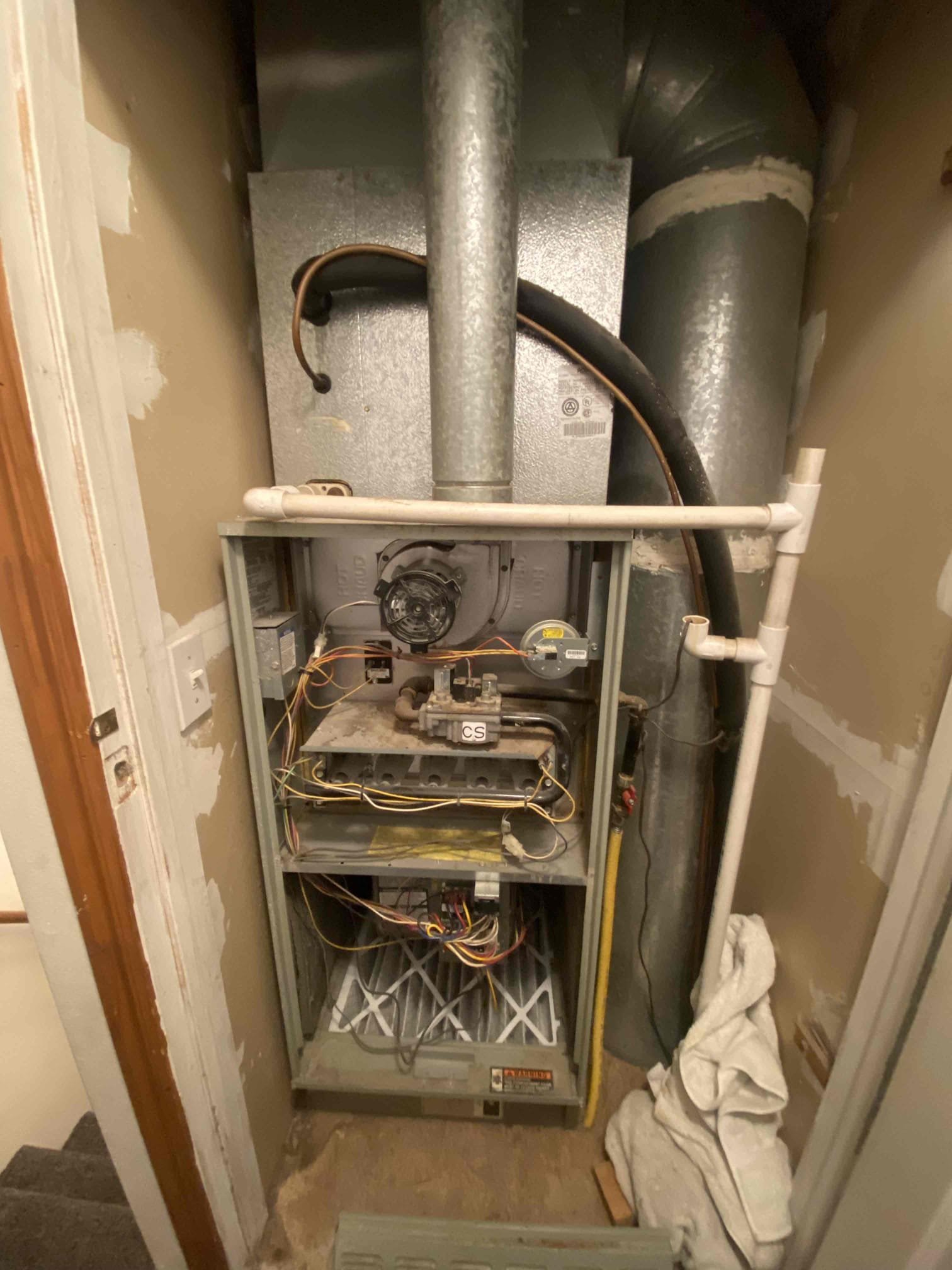 A sleek, white hidden mini-split unit seamlessly integrated into a modern living room wall, showcasing a clean and uncluttered aesthetic. The discreet design highlights the benefit of space-saving and quiet operation, ideal for homeowners seeking residential HVAC solutions and AC service nearby.