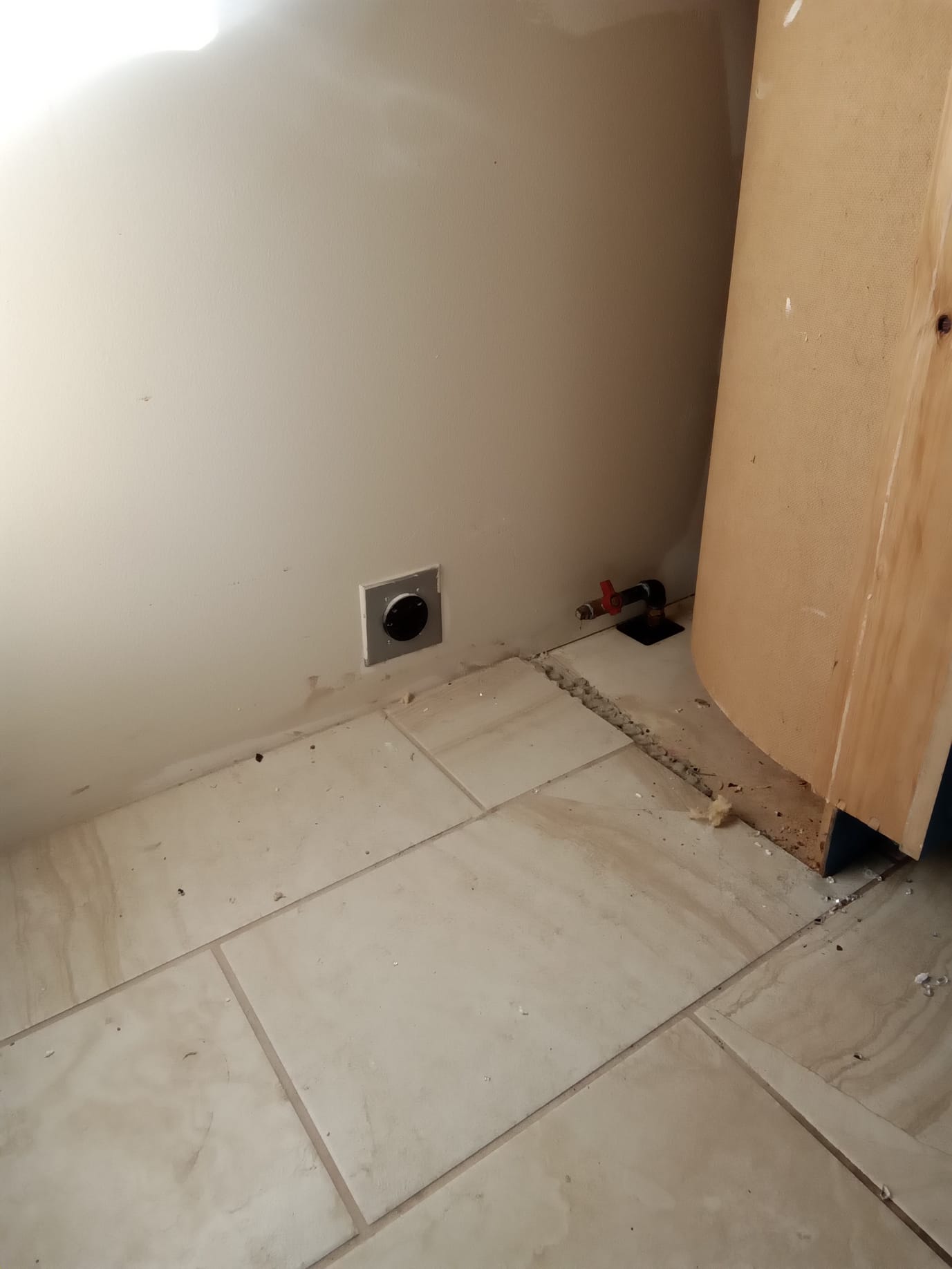 Aftermath of a wildfire reveals a room with sheetrock damage due to smoke contamination. Cleaned section showcases restored wall, highlighting the potential for complete smoke damage remediation.