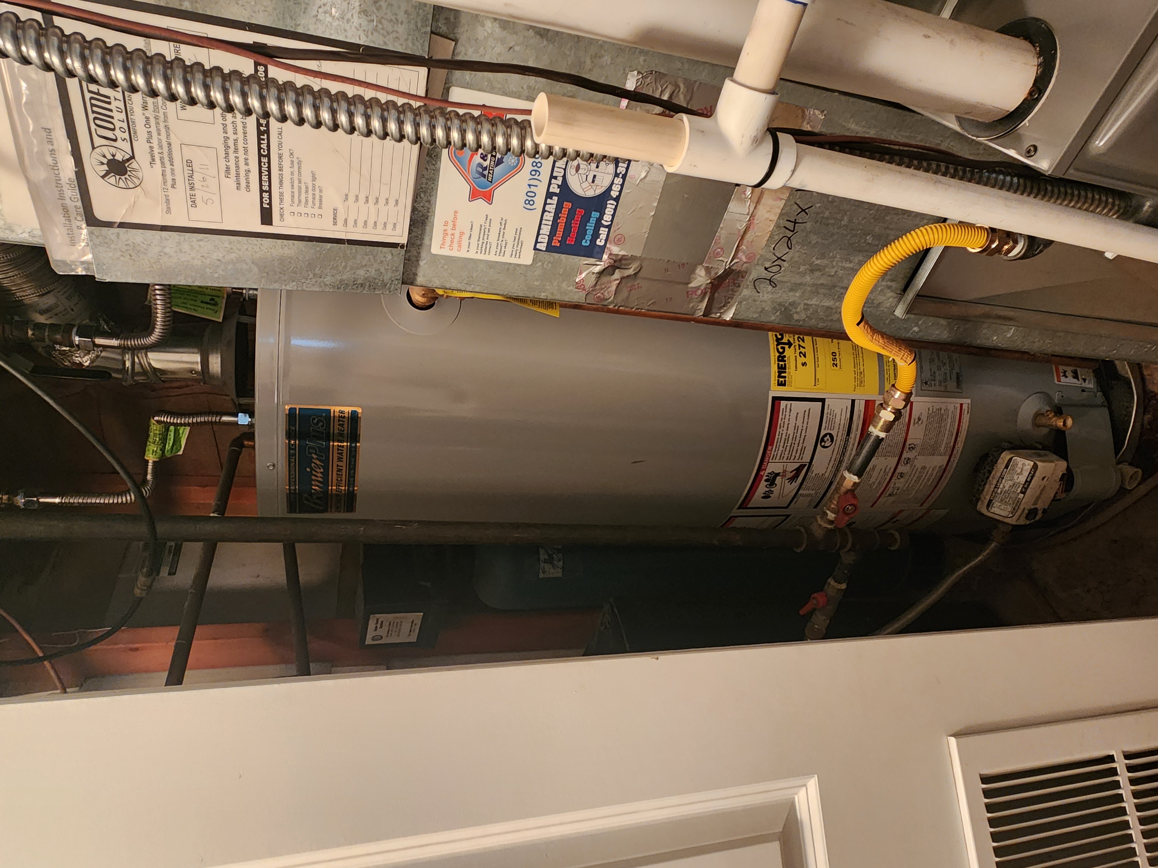 Clean, bright wall after drywall repair, symbolizing odor removal success. A nearby RO water filter installation hints at proactive prevention of future water damage, suggesting cost savings on extensive repairs.