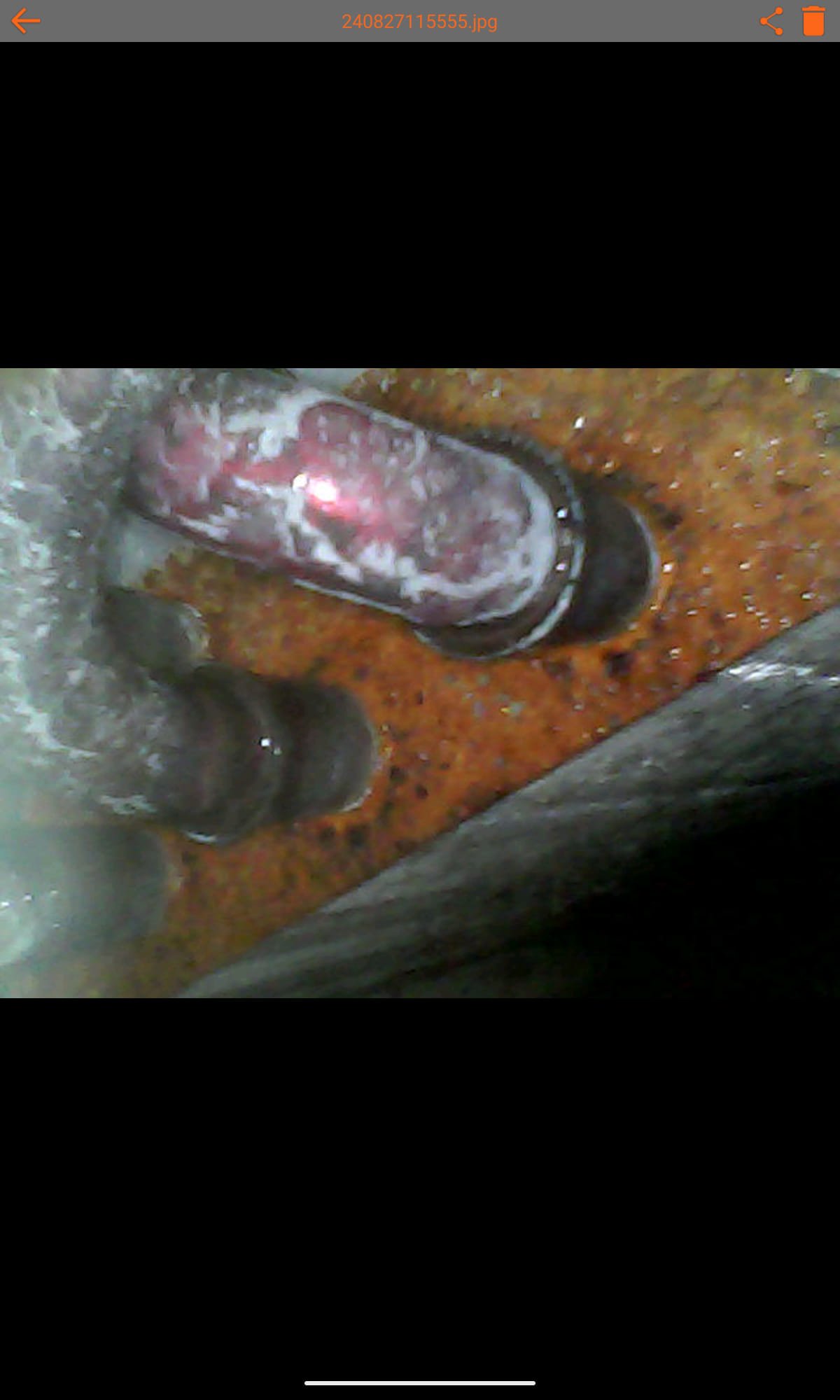 Worried homeowner smiles as a technician expertly repairs their gas heater. Flames burn safely inside the unit, highlighting reliable warmth and fire safety. Background shows a cozy, secure home, emphasizing peace of mind.