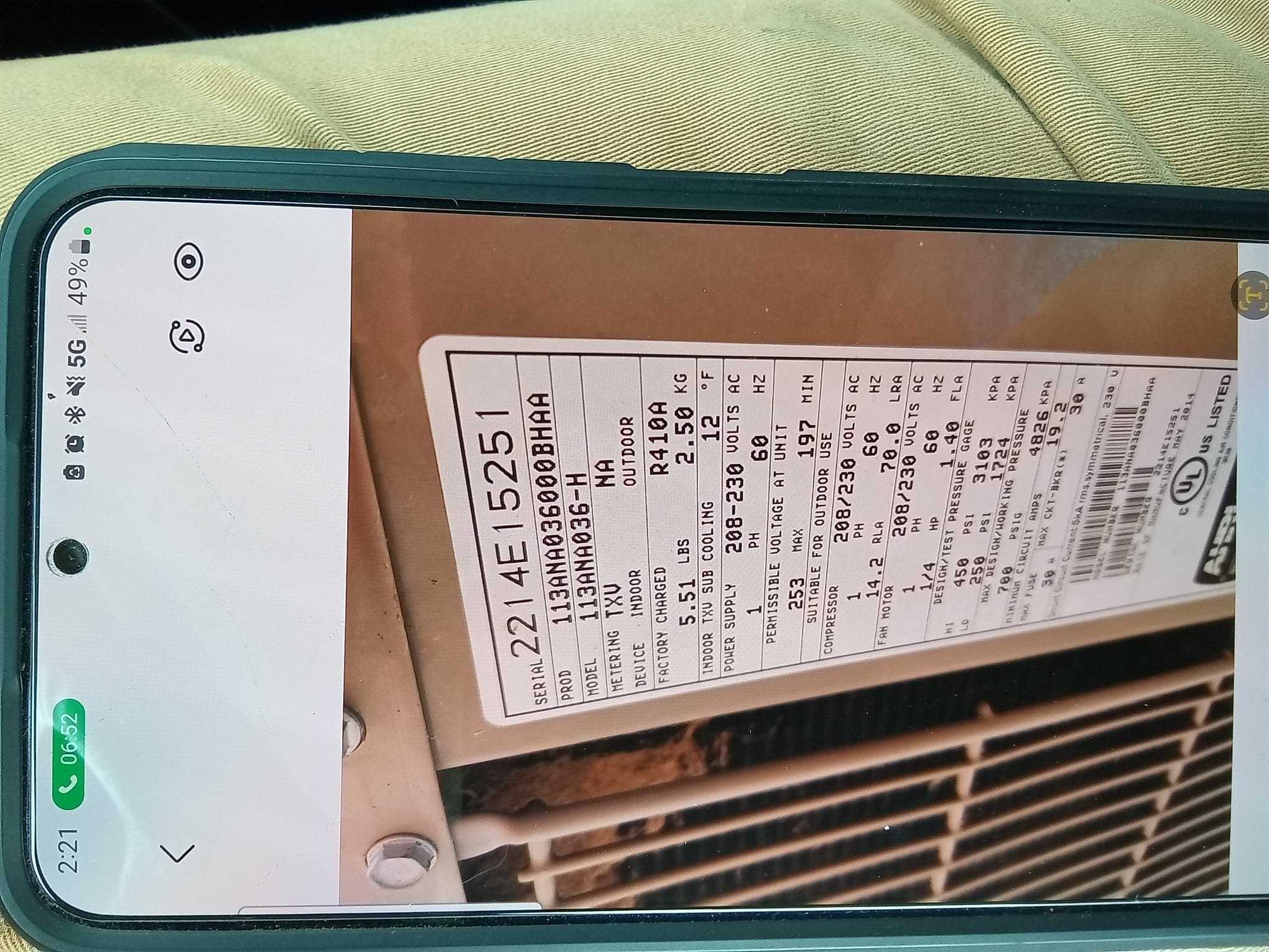 A family smiles comfortably in their living room, bathed in soft, cool light, showcasing the benefits of reliable residential AC repair and installation. A subtle call-to-action number is displayed, suggesting prompt, professional service.
