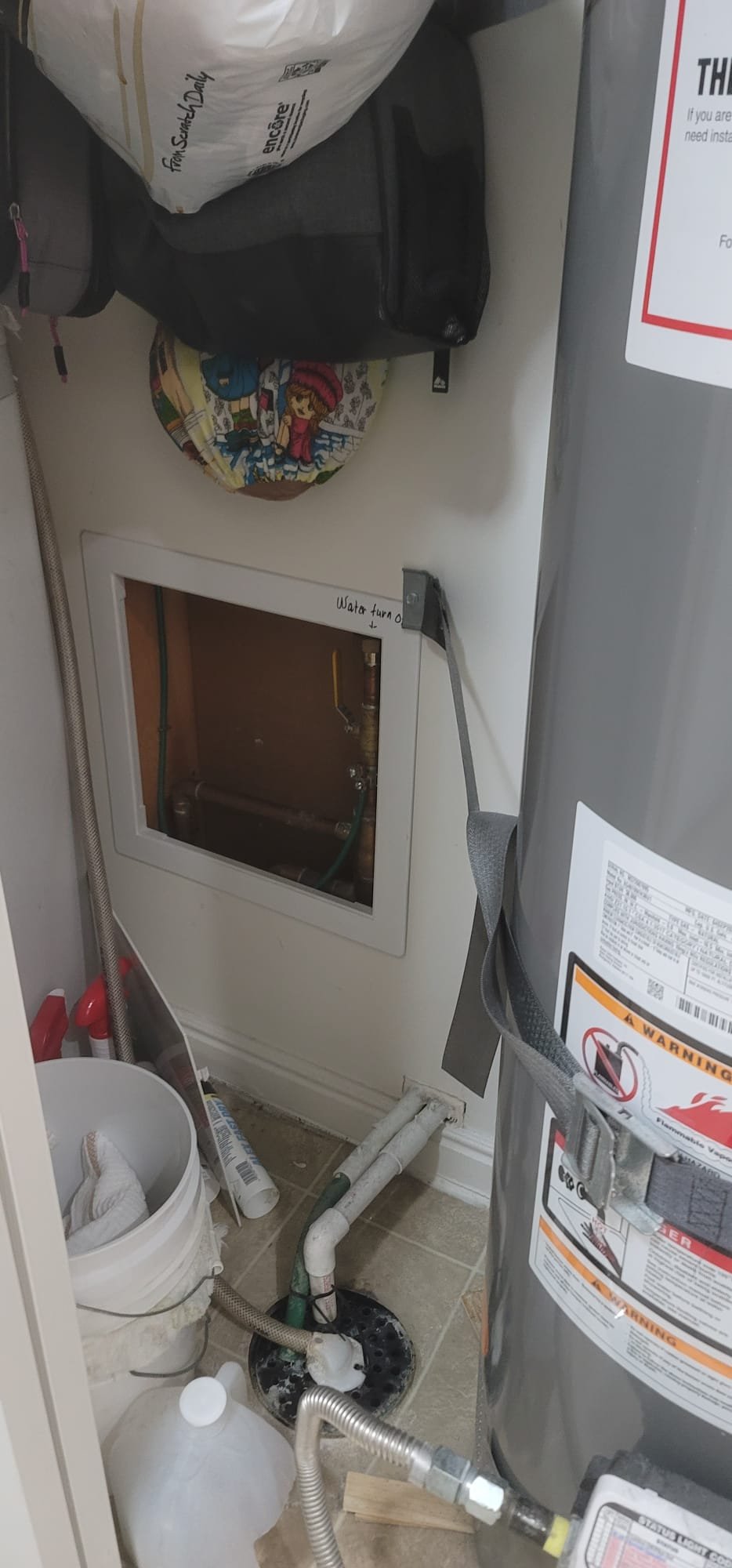 Large, modern water softener installed in a clean basement, suggesting effective water damage prevention. Visible pipes are neatly organized, implying professional installation and reliable protection against leaks and water damage. A dry, finished basement in the background indicates the success of basement water damage remediation.