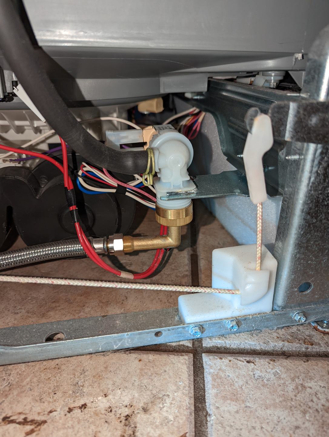 Image of a clean kitchen sink after disaster restoration, focusing on the disposal area. A hand presses the reset button on the disposal, symbolizing problem resolution and a return to normalcy. The sink's cleanliness highlights the benefits of professional disaster restoration, emphasizing a fresh start after damage. The reset button being pressed illustrates a simple solution to a common issue, showcasing a step towards complete recovery.