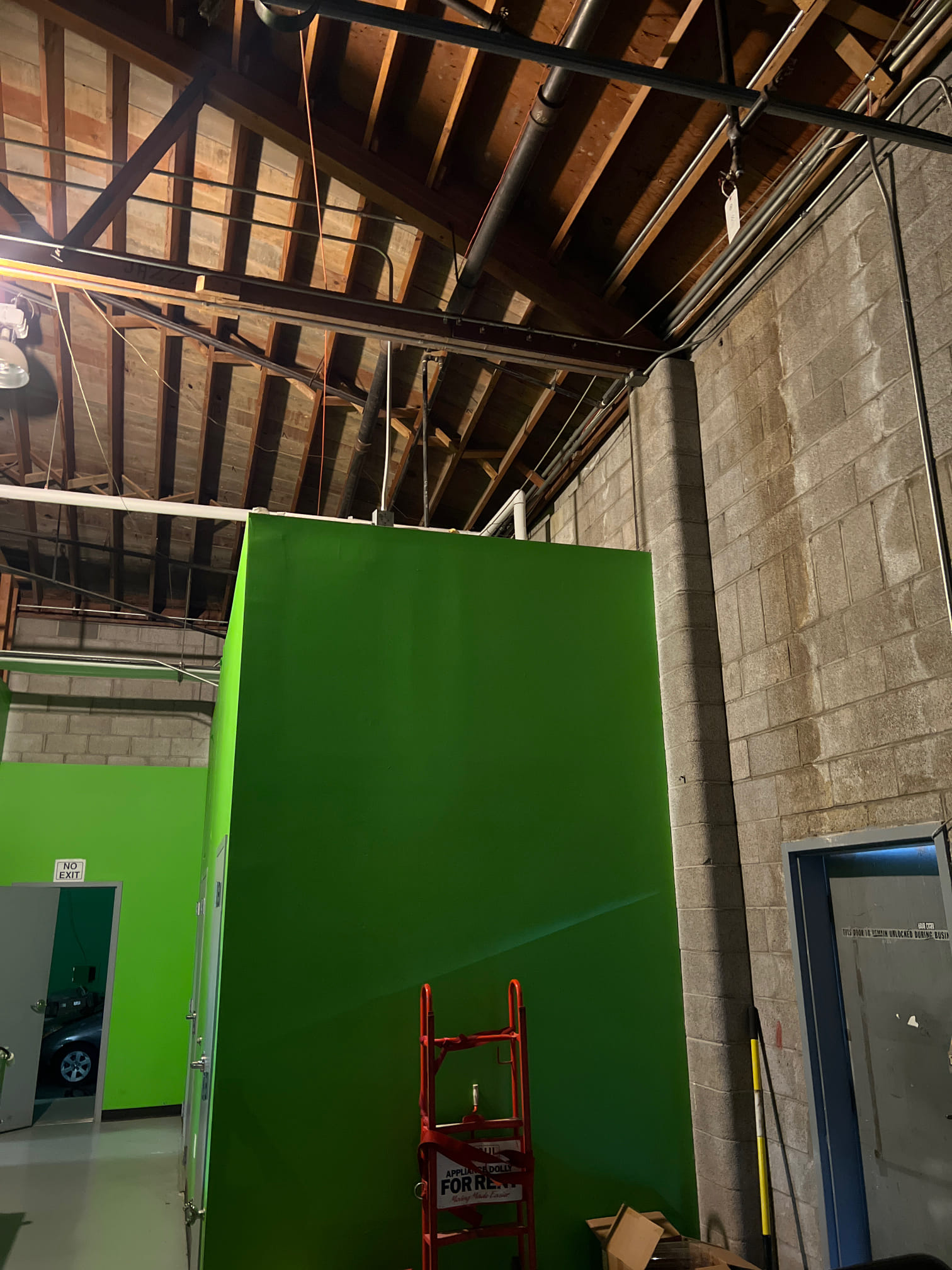 After a storm, a brightly lit home stands resilient amidst neighborhood damage, showcasing quick, effective residential remediation and offering peace of mind.