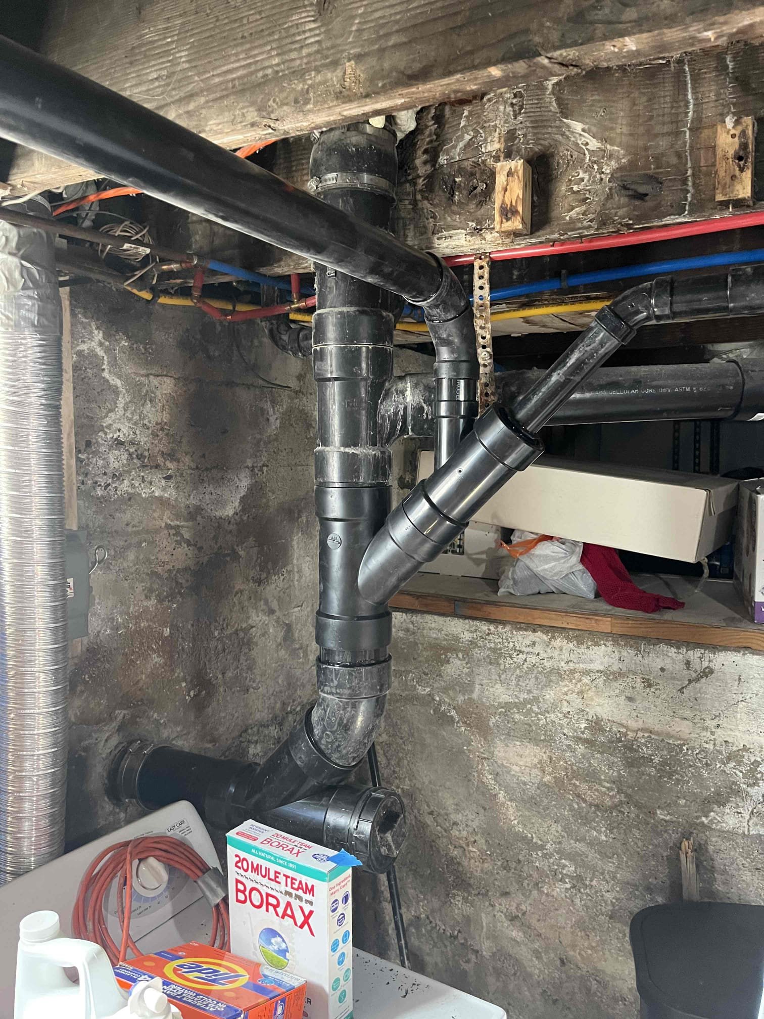 Clean, dry basement with air purifier, representing professional sewage odor removal. Eliminates sewage odor after basement backup, offering a fresh, healthy environment. Visualizes the benefits of a basement sewage backup odor removal estimate.